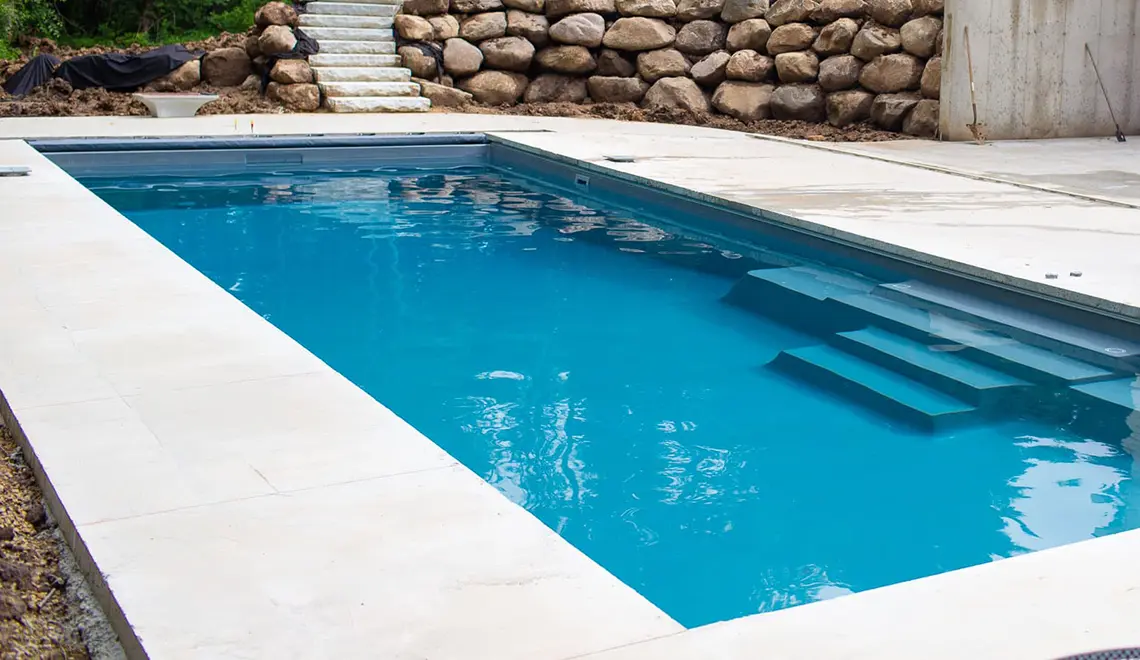 Leisure Pools The Grand rectangular fiberglass pool side view by Leisure Pools Lake City